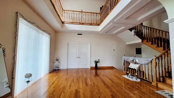 a living room with fireplace furniture and a large window