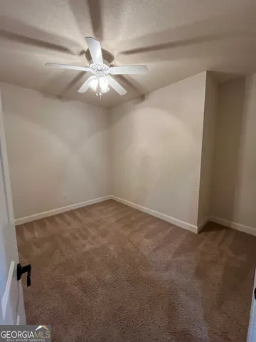 en view interior of a house with a ceiling fan and wooden floor