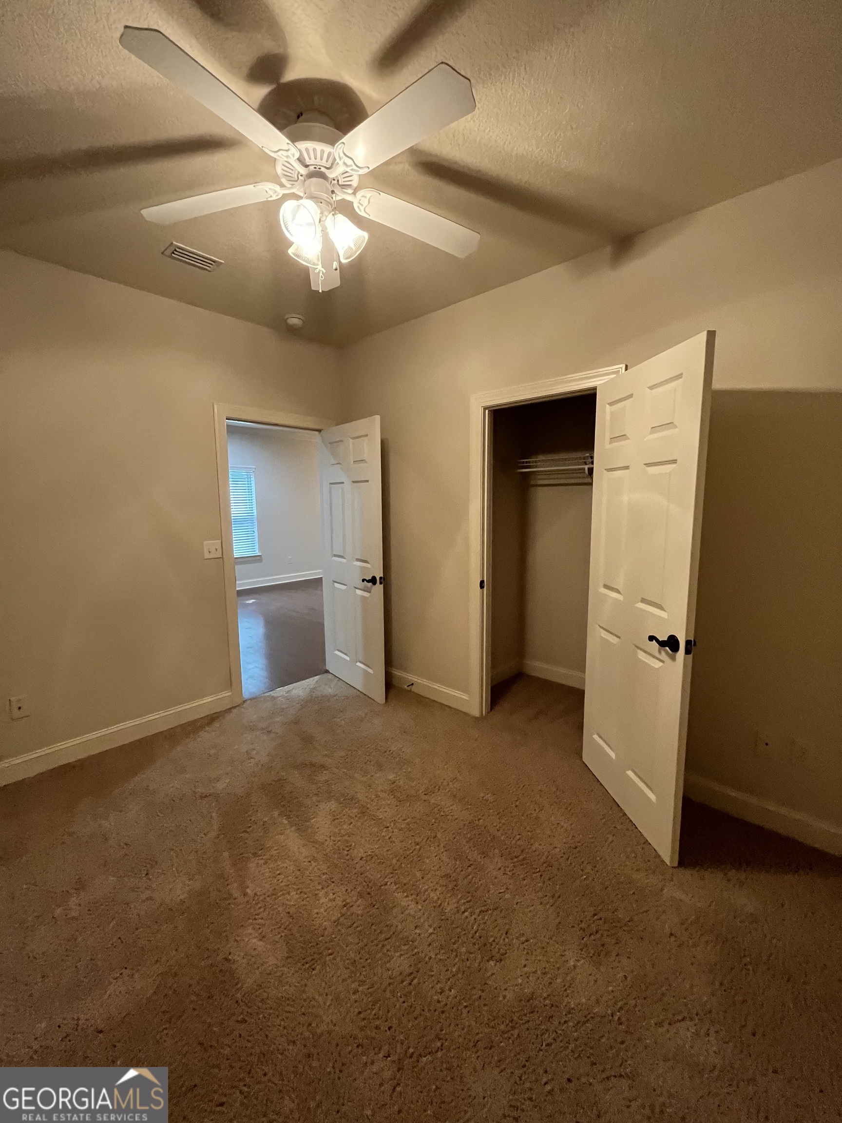 708 Osborne Street, Unit 206 St. Marys, GA 31558 - Photo 19 of 27 en view interior of a house with a ceiling fan and wooden floor