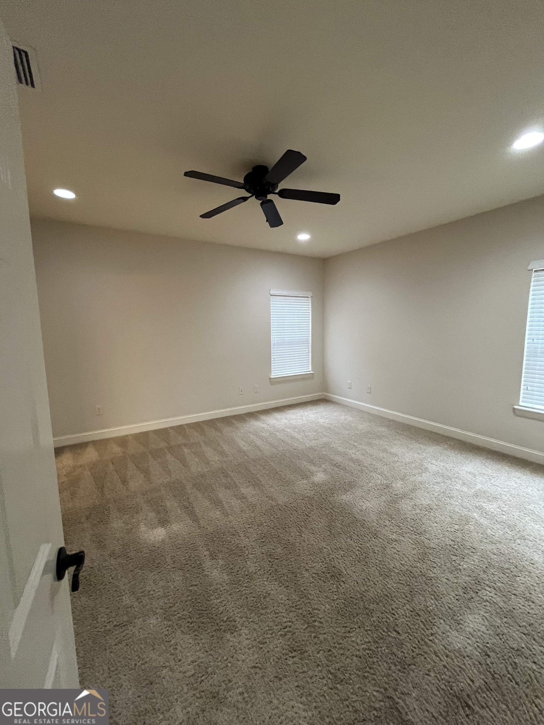 708 Osborne Street, Unit 206 St. Marys, GA 31558 - Photo 21 of 27 an empty room with windows and fan