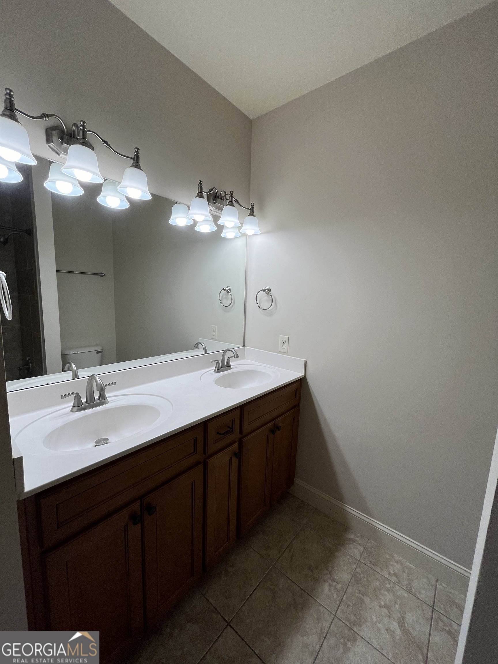 708 Osborne Street, Unit 206 St. Marys, GA 31558 - Photo 25 of 27 a bathroom with a double vanity sink and a mirror