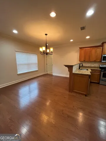 a view of kitchen with cabinets and wooden floor