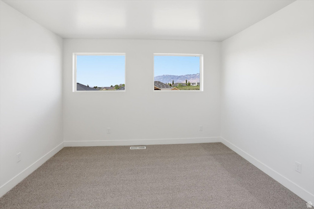 1315 West 3200 South, Unit 17 Perry, UT 84302 - Photo 45 of 58 Bright interior space with two rectangular windows offering distant mountain scenery