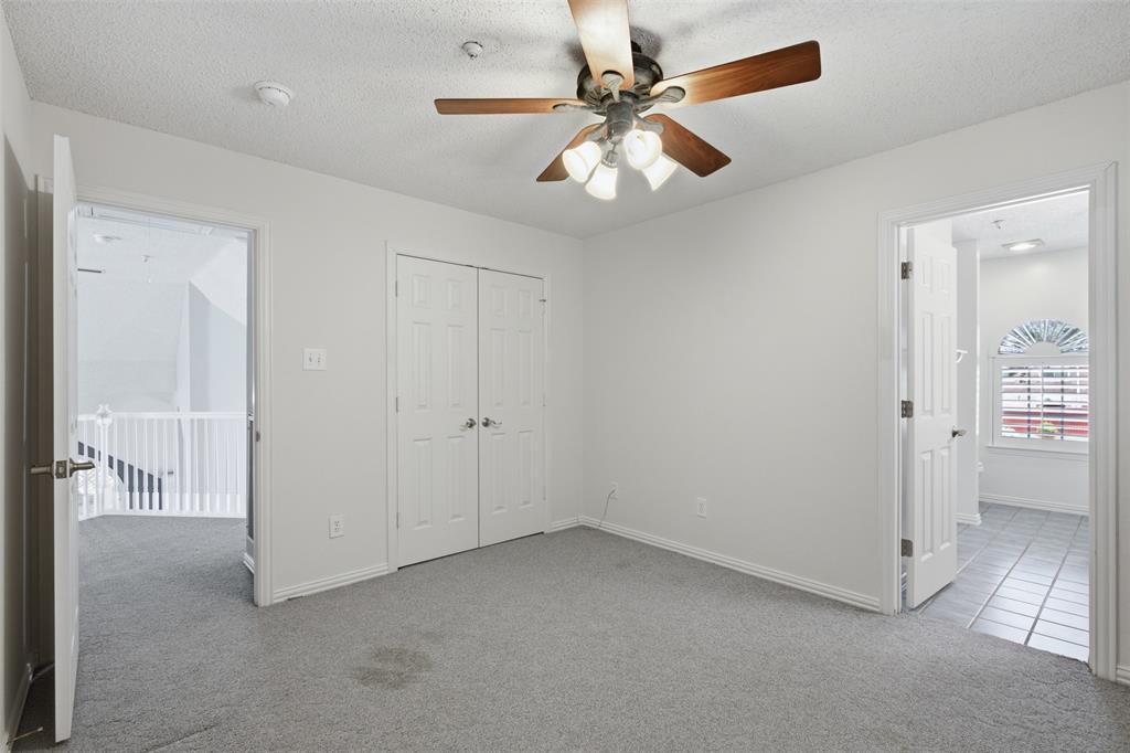 14584 Blueberry Court Addison, TX 75001 - Photo 32 of 40 an empty room with fan and windows