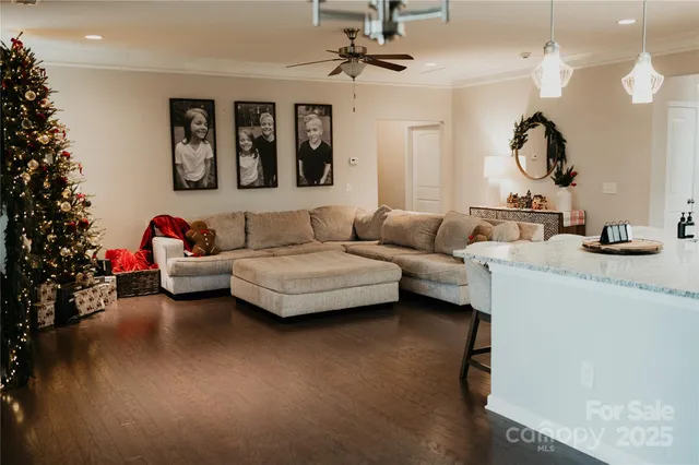 a living room with furniture a chandelier and a mirror