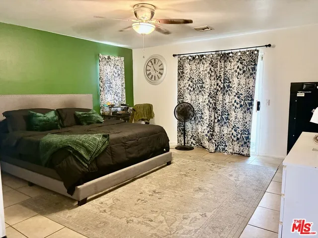 a bedroom with a bed window and wall painting