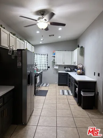 a kitchen with stainless steel appliances granite countertop a refrigerator a stove a sink and a microwave