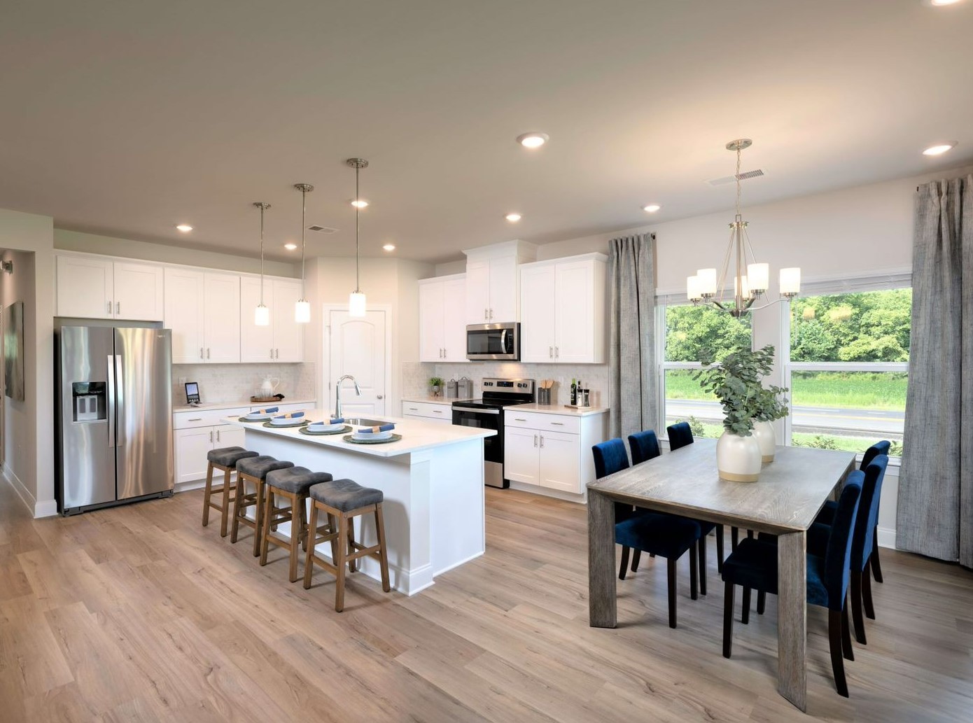 7413 Blue Gable Road Hermitage, TN 37076 - Photo 5 of 13 a kitchen with kitchen island wooden floor dining table and chairs