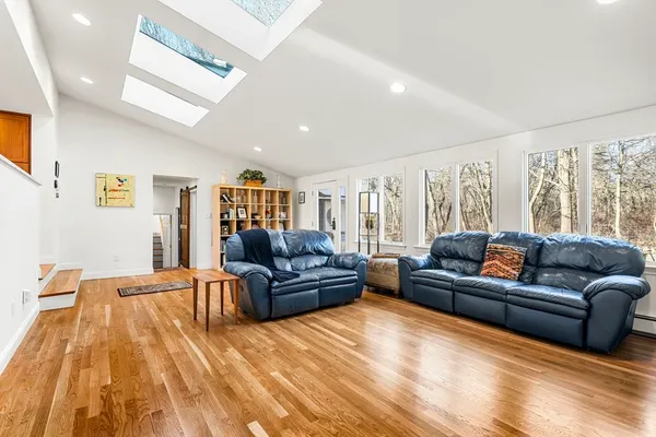 a living room with a couch and large windows