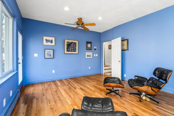 a room with gym equipment and a wooden floor