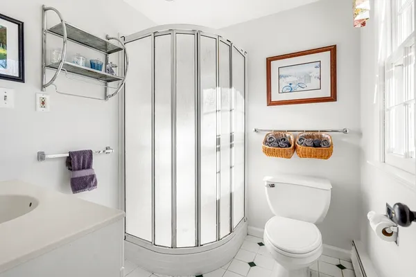 a bathroom with a toilet a sink and a shower