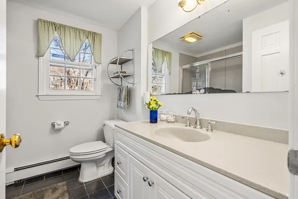 a bathroom with a sink mirror and toilet