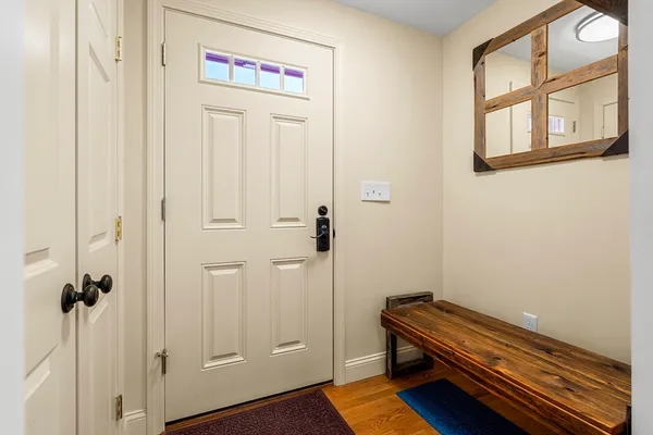 a view of room with wooden floor and cabinet