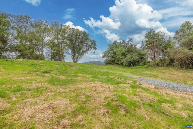 a view of a field with an trees
