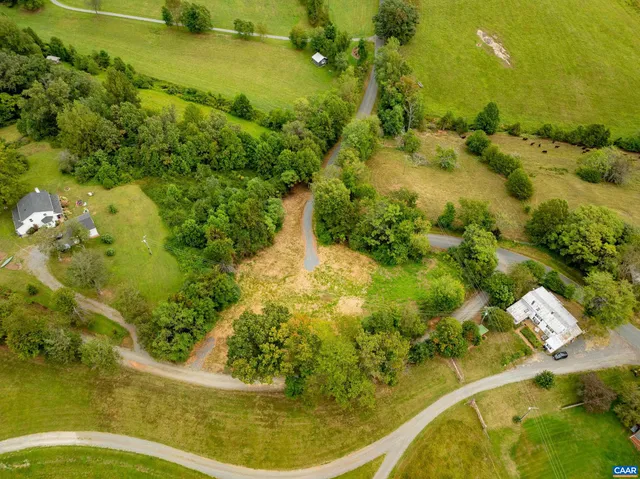 an aerial view of a residential houses with outdoor space and swimming pool