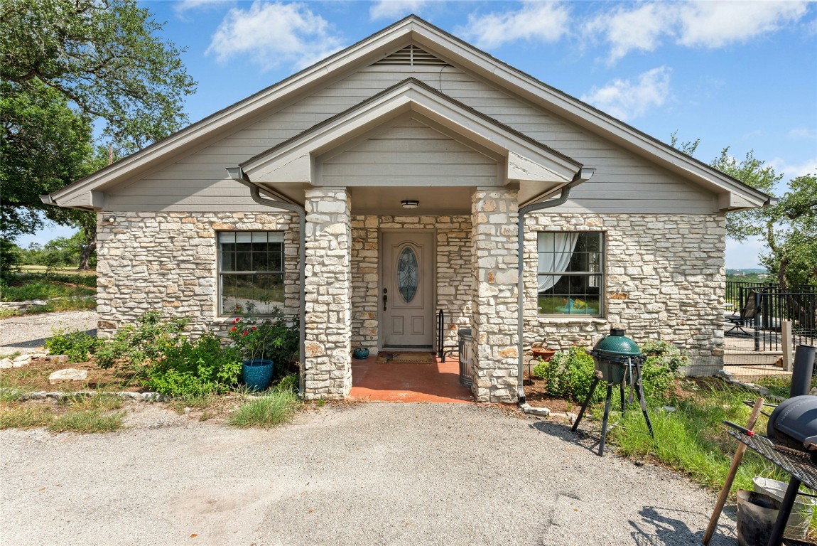 110 Longhorn Lane Dripping Springs, TX 78620 - Photo 20 of 40 a front view of a house with garden