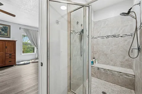 a bathroom with a glass shower door