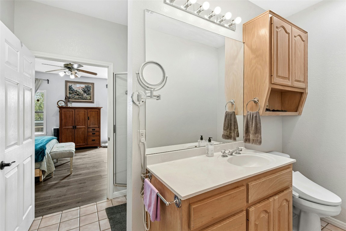 110 Longhorn Lane Dripping Springs, TX 78620 - Photo 24 of 40 a bathroom with a sink vanity granite and a mirror