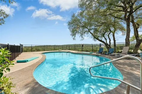 a view of a swimming pool with a yard
