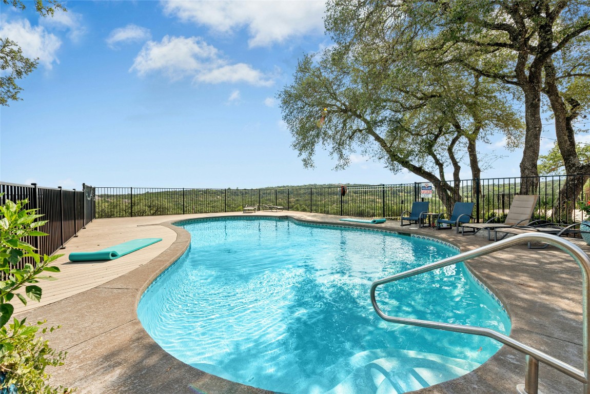 110 Longhorn Lane Dripping Springs, TX 78620 - Photo 26 of 40 a view of a swimming pool with a yard
