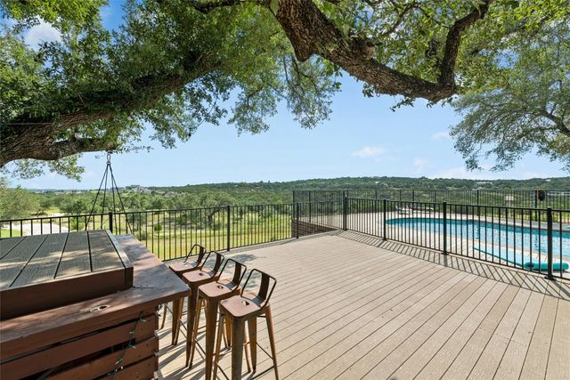 a view of a balcony with wooden floor and lake view