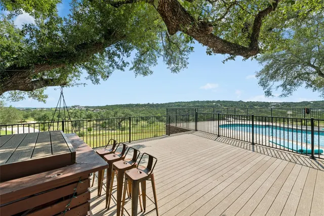 a view of a balcony with wooden floor and lake view
