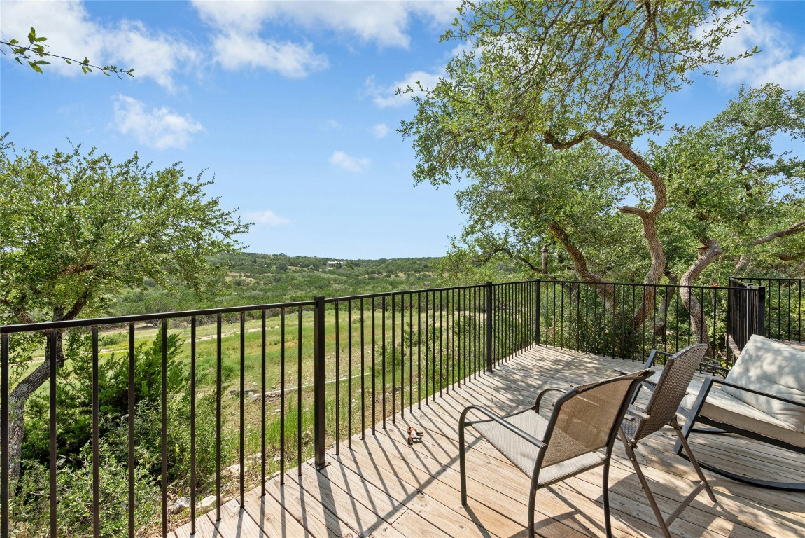 110 Longhorn Lane Dripping Springs, TX 78620 - Photo 28 of 40 a view of a balcony with wooden floor and outdoor seating