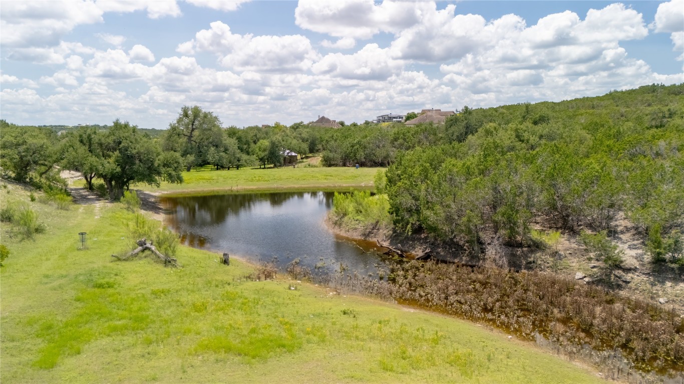 110 Longhorn Lane Dripping Springs, TX 78620 - Photo 34 of 40 a view of a lake with houses in the back