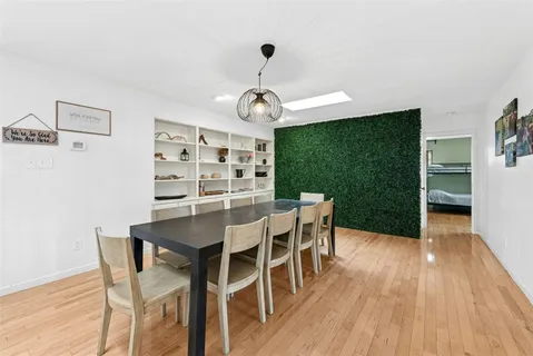a view of a dining room with furniture wooden floor and chandelier