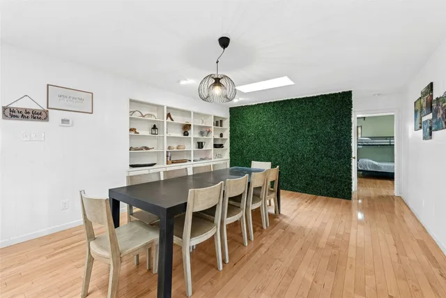 a view of a dining room with furniture wooden floor and chandelier