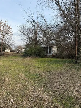 a view of a house with a yard and sitting area