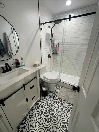 a bathroom with a sink toilet and shower