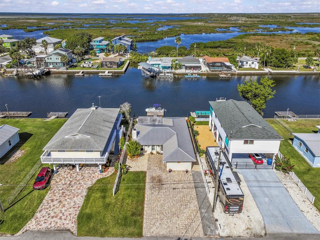 3391 Mangrove Drive Hernando Beach, FL 34607 - Photo 13 of 52 an aerial view of residential houses with outdoor space and lake view
