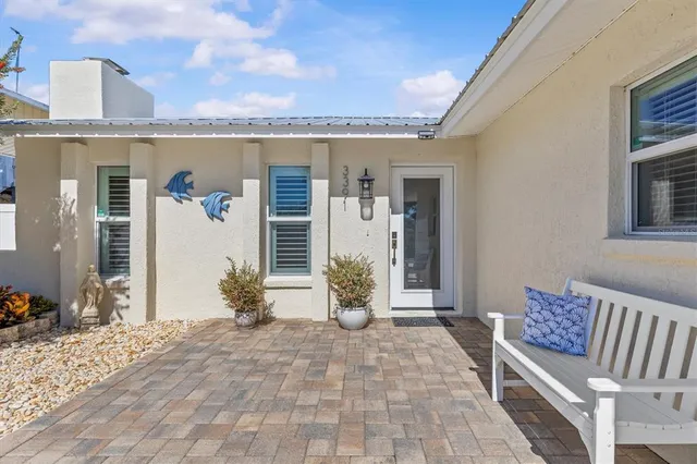 a living room with furniture a fireplace and a large window
