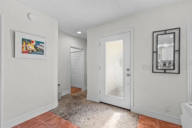 a living room with furniture a fireplace and a large window