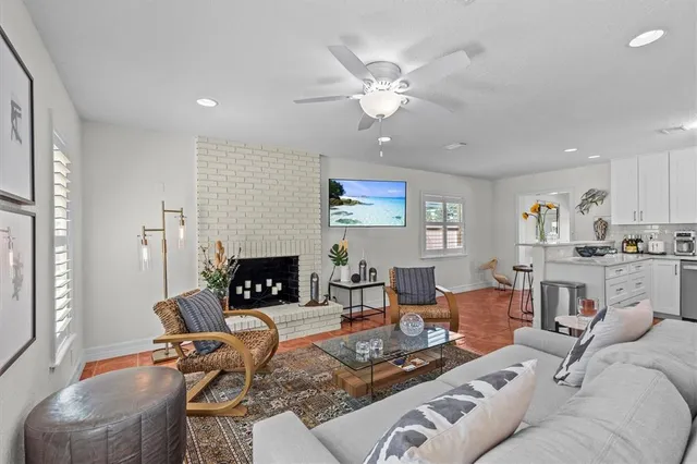 a living room with furniture and kitchen view