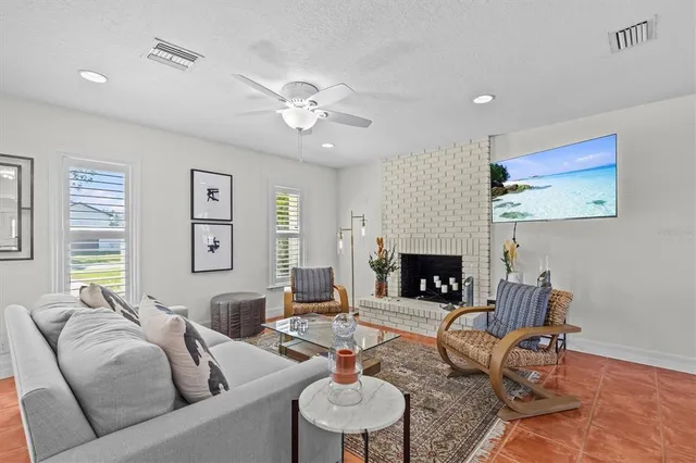 a kitchen with stainless steel appliances granite countertop a refrigerator and a stove top oven with wooden floor