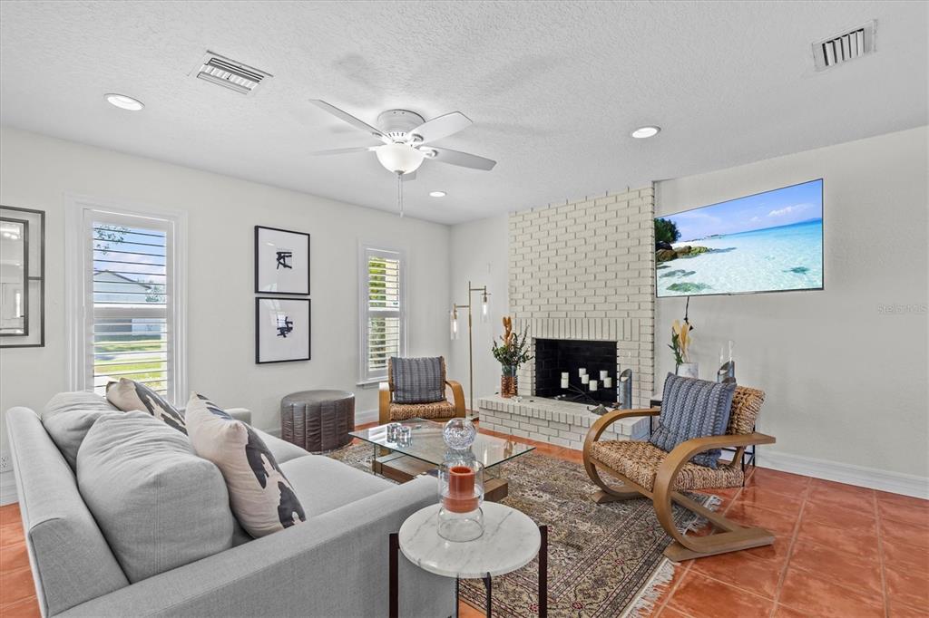 3391 Mangrove Drive Hernando Beach, FL 34607 - Photo 19 of 52 a living room with furniture a fireplace and a large window
