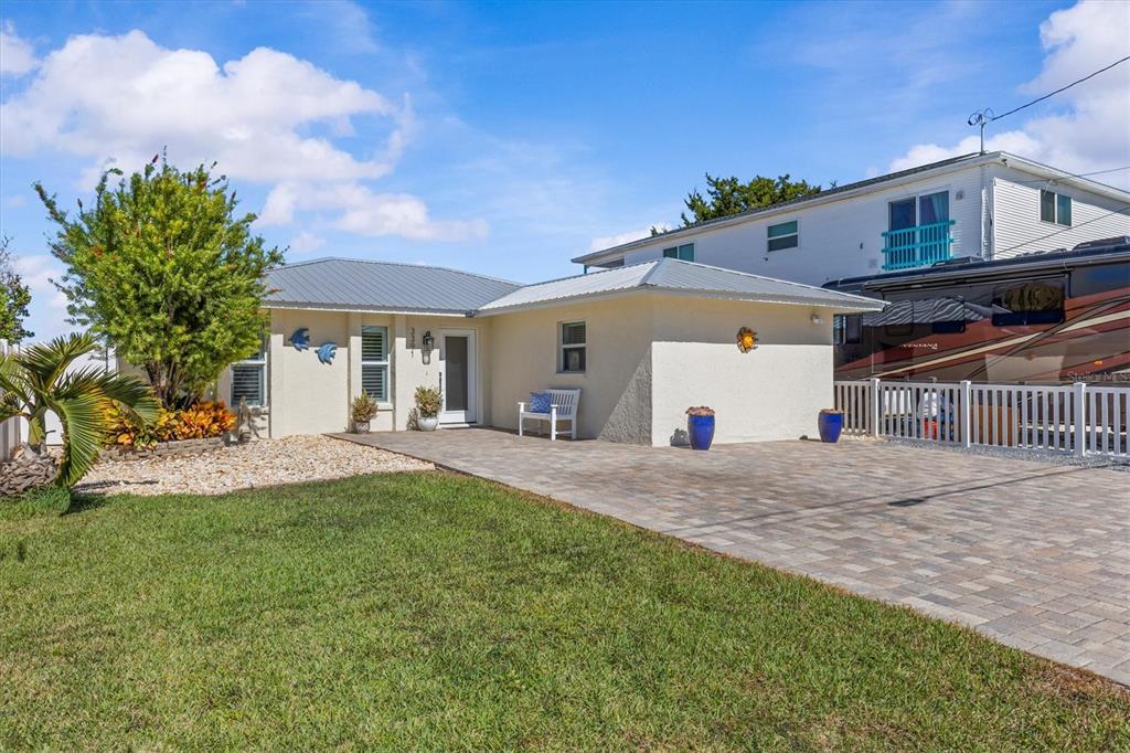 3391 Mangrove Drive Hernando Beach, FL 34607 - Photo 2 of 52 a view of a house with a backyard and a garage