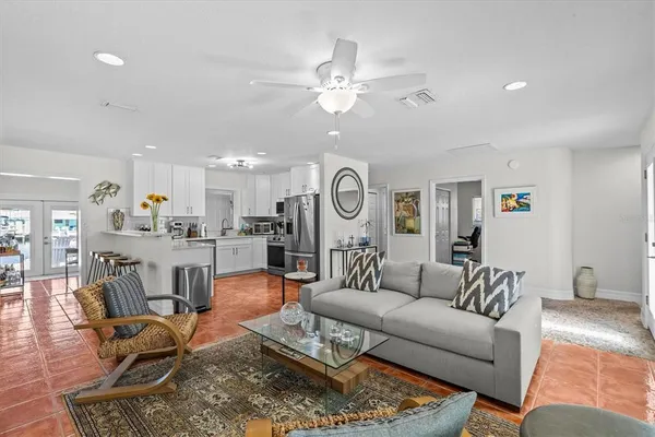 a kitchen with stainless steel appliances granite countertop a refrigerator sink and microwave