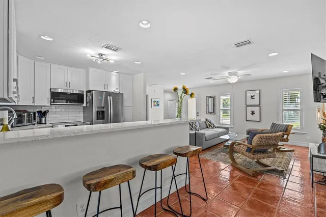 a kitchen with a sink a refrigerator and cabinets