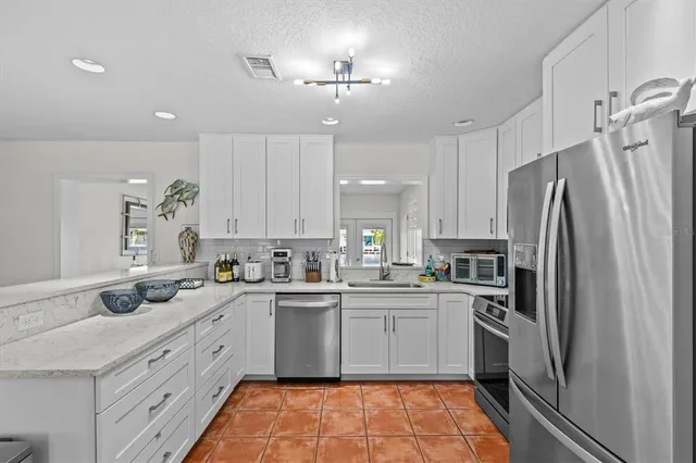 a view of a livingroom with furniture and a table kitchen
