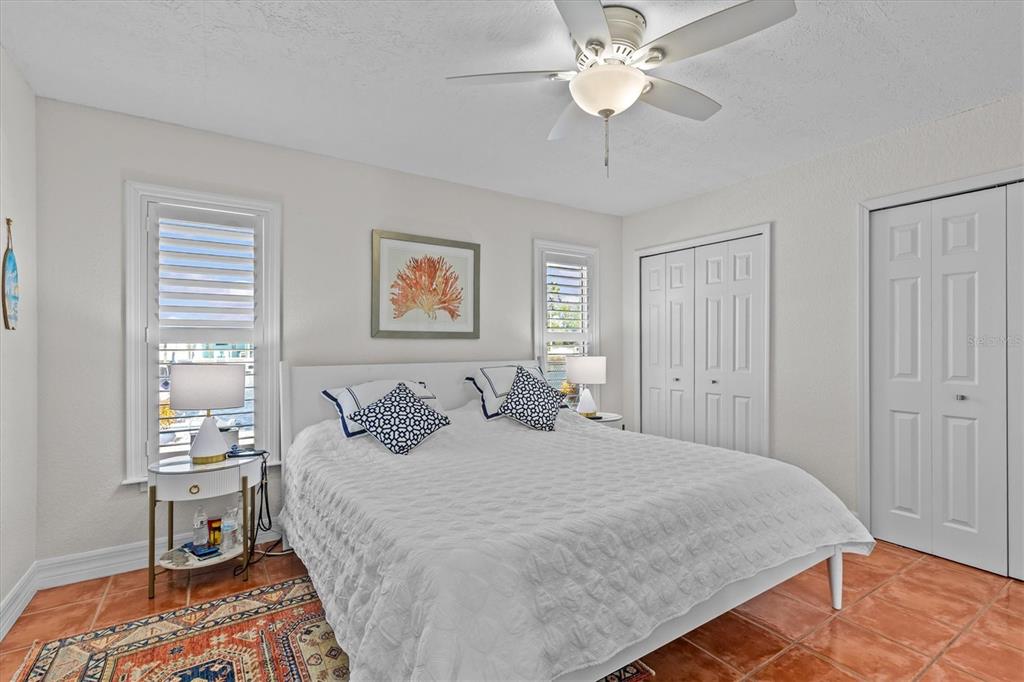 3391 Mangrove Drive Hernando Beach, FL 34607 - Photo 33 of 52 a bedroom with a bed and a chandelier