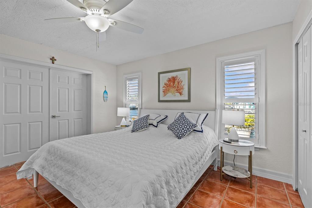3391 Mangrove Drive Hernando Beach, FL 34607 - Photo 34 of 52 a bedroom with a bed and a chandelier