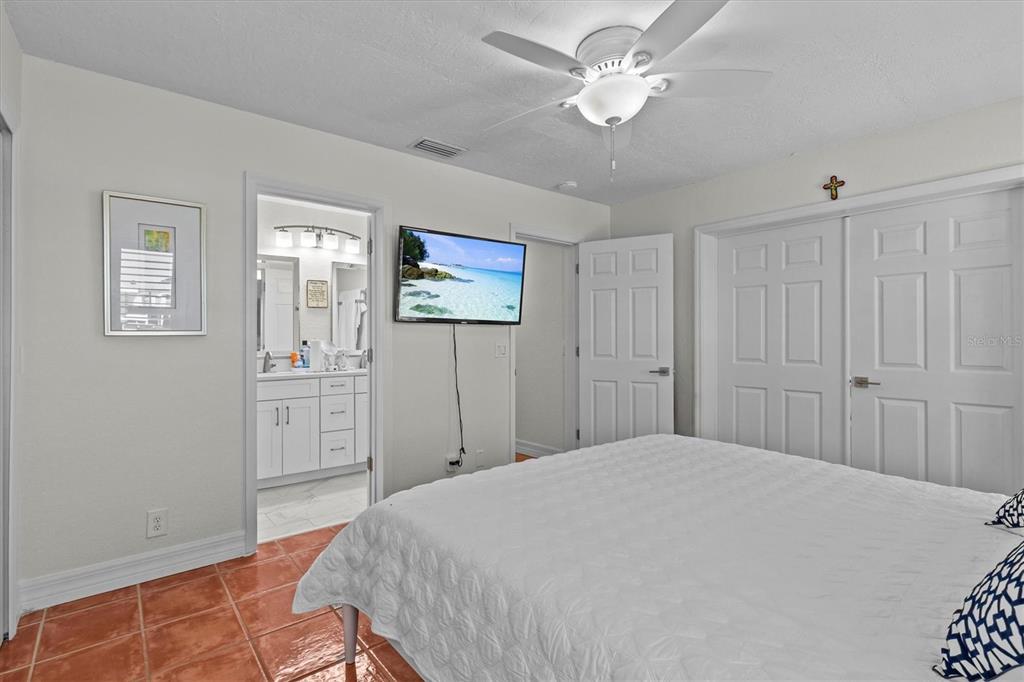 3391 Mangrove Drive Hernando Beach, FL 34607 - Photo 35 of 52 a bedroom with a bed and a chandelier