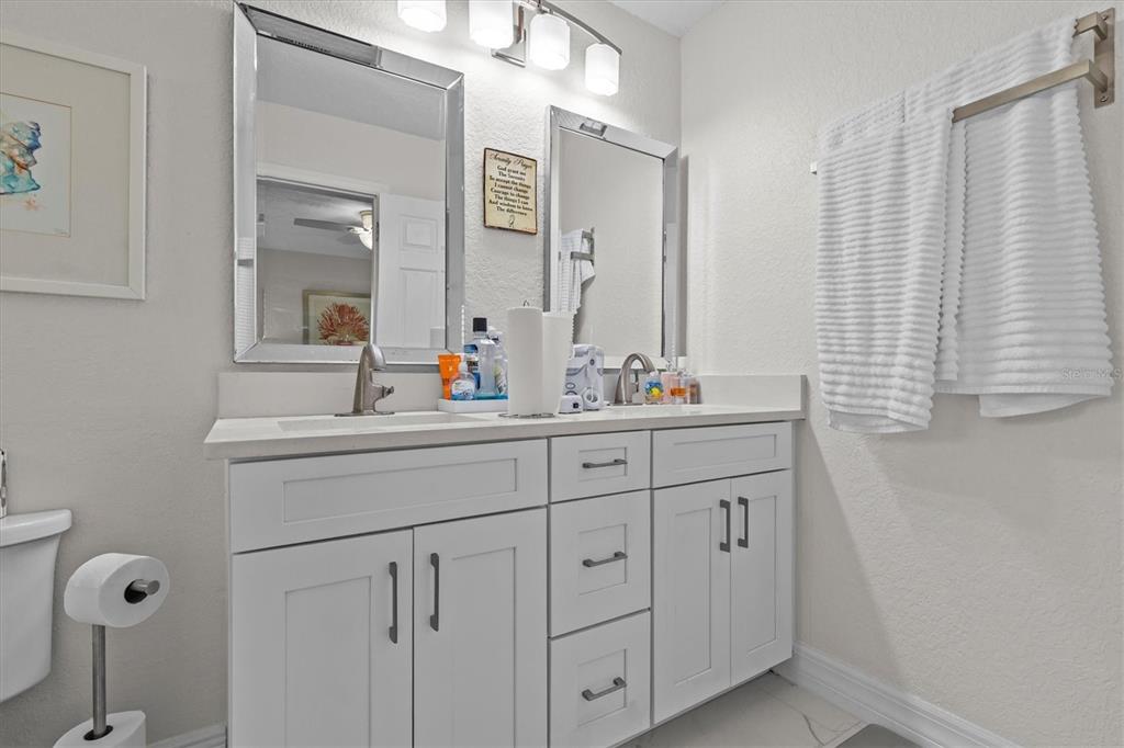3391 Mangrove Drive Hernando Beach, FL 34607 - Photo 36 of 52 a bathroom with double sink and a mirror