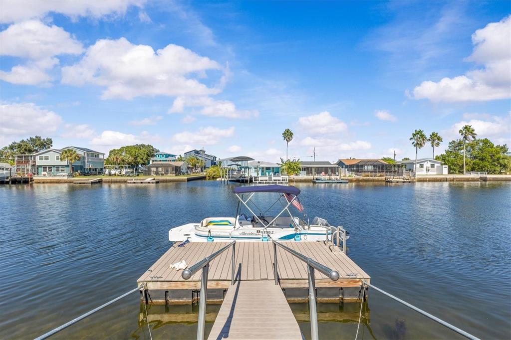 3391 Mangrove Drive Hernando Beach, FL 34607 - Photo 46 of 52 a view of a lake with boats and trees in the background