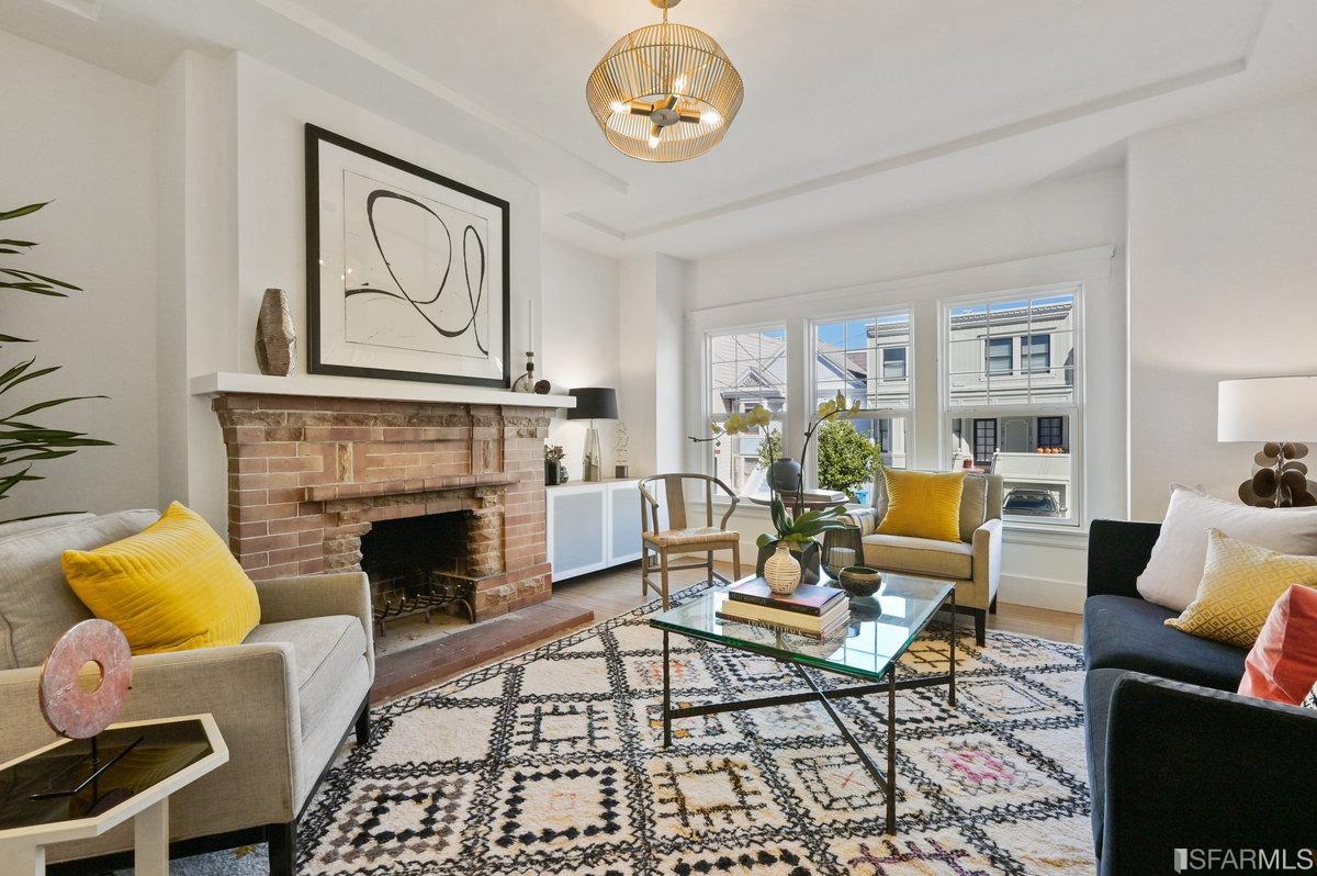 a living room with furniture a rug and a fireplace