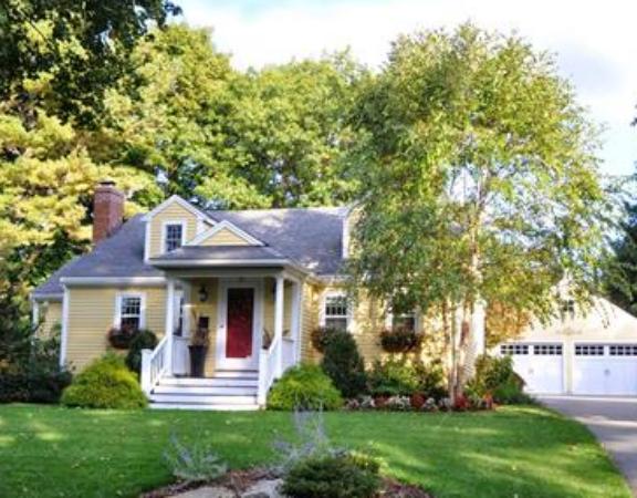a front view of a house with a yard table and chairs
