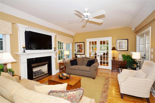 31 MacArthur Road Concord, MA 01742 - Photo 11 of 30 a living room with furniture a fireplace and a flat screen tv